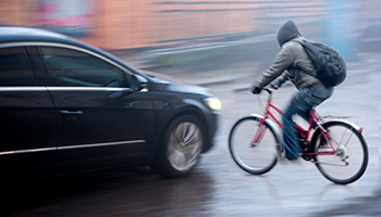 traffic situation with cyclist and car in the city in motion blur