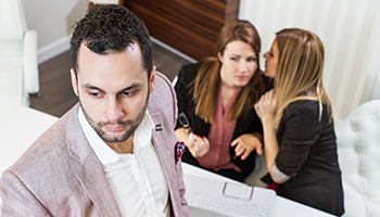 Businessman portrait and co-workers out of focus in background