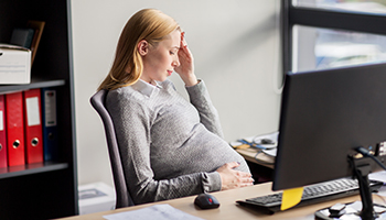 Pregnant businesswoman feeling sick